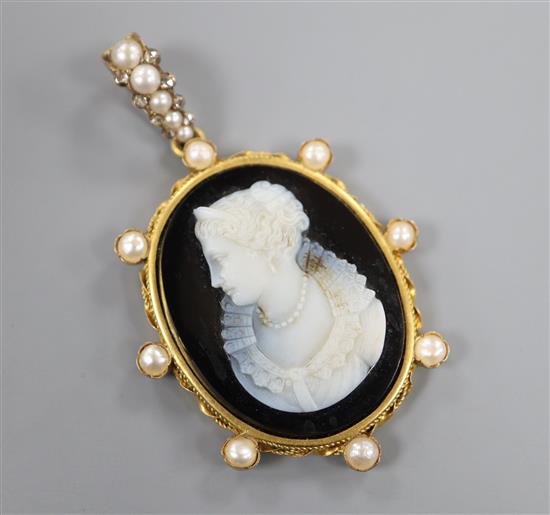 A late 19th century continental yellow metal and split pearl set sardonyx cameo pendant,